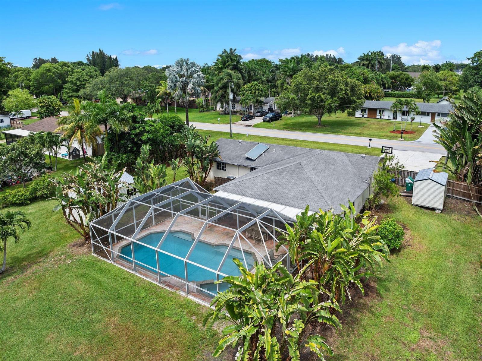 An aerial view of a house with a screened-in pool and a large backyard — 5191 SW 188th Avenue, Southwest Ranches FL 33332, SOUTHWEST RANCHES, FL