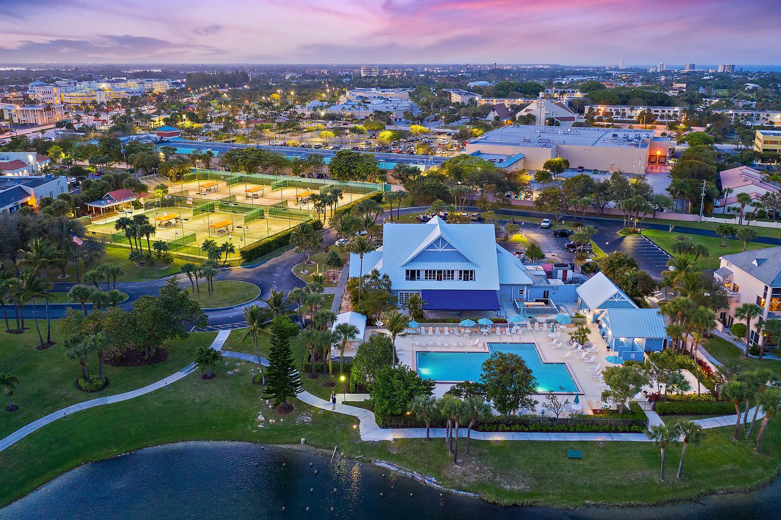 An aerial view shows a community clubhouse with a swimming pool and tennis courts — 353 S Us Hwy 1 # C7, Jupiter FL 33477, JUPITER, FL