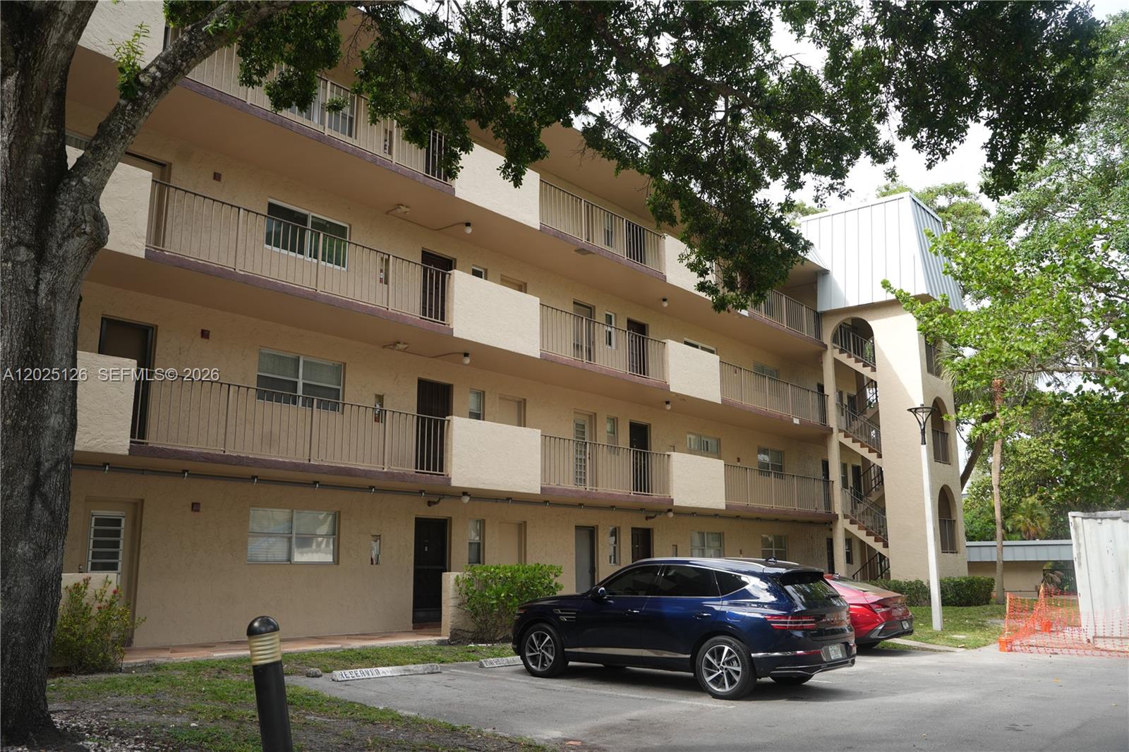 A three-story apartment building with exterior walkways and a parking lot in front — 6001 N Falls Cir Dr # 203, Lauderhill FL 33319, LAUDERHILL, FL