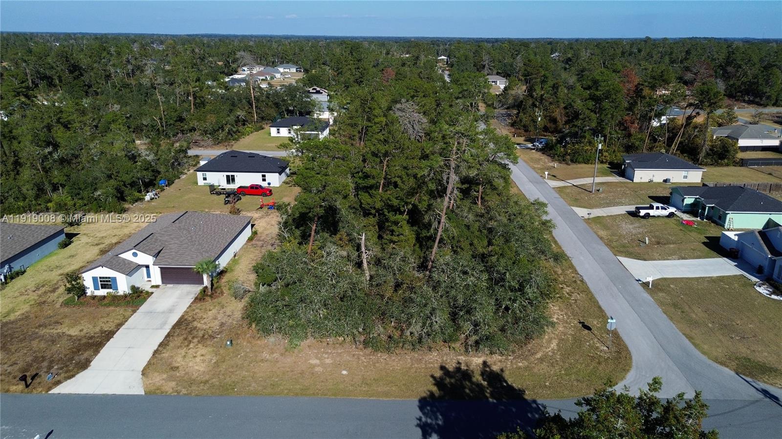 An aerial view shows a vacant, wooded lot situated between two residential houses — 0 SW 167th Loop, Ocala FL 34473, OCALA, FL
