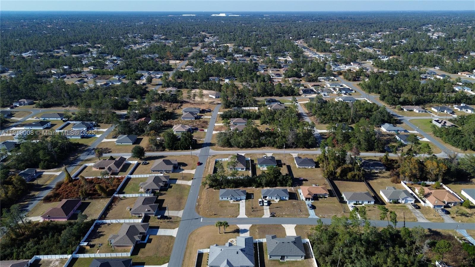 An aerial view shows a suburban neighborhood with single-family homes surrounded by dense pine forests — 0 SW 167th Loop, Ocala FL 34473, OCALA, FL