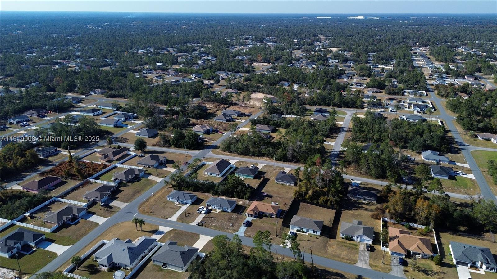 An aerial view shows a suburban neighborhood with single-family homes surrounded by dense pine forests — 0 SW 167th Loop, Ocala FL 34473, OCALA, FL