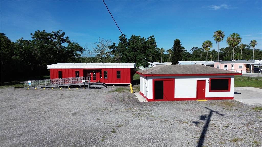 An aerial view shows a red modular building and a white building with red trim — 4109 US HIGHWAY 27 S, SEBRING, FL
