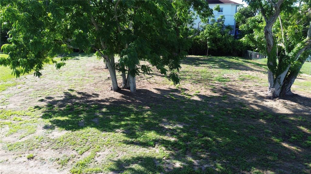 An aerial view of a grassy, partially shaded lot with several large trees — 4109 US HIGHWAY 27 S, SEBRING, FL