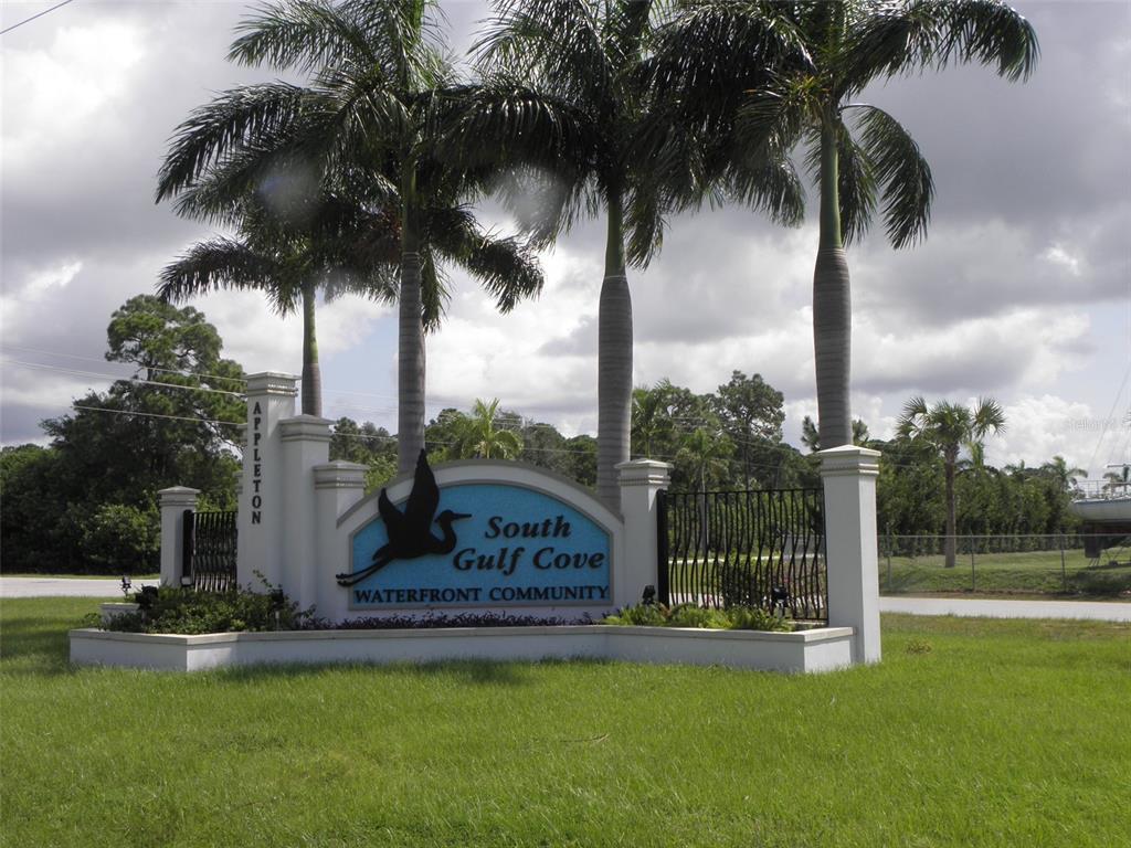 A stone monument sign for South Gulf Cove Waterfront Community stands in a grassy area — 10311 REDONDO STREET, PORT CHARLOTTE, FL