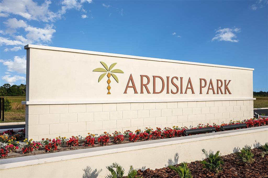 A beige monument sign for Ardisia Park stands outdoors against a blue sky — 691 MOON SHELL CIRCLE, NEW SMYRNA BEACH, FL