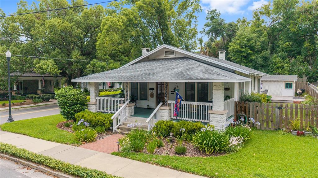 A single-story house with a white porch, stone pillars, and a brick walkway — 505 SE SANCHEZ AVENUE, OCALA, FL