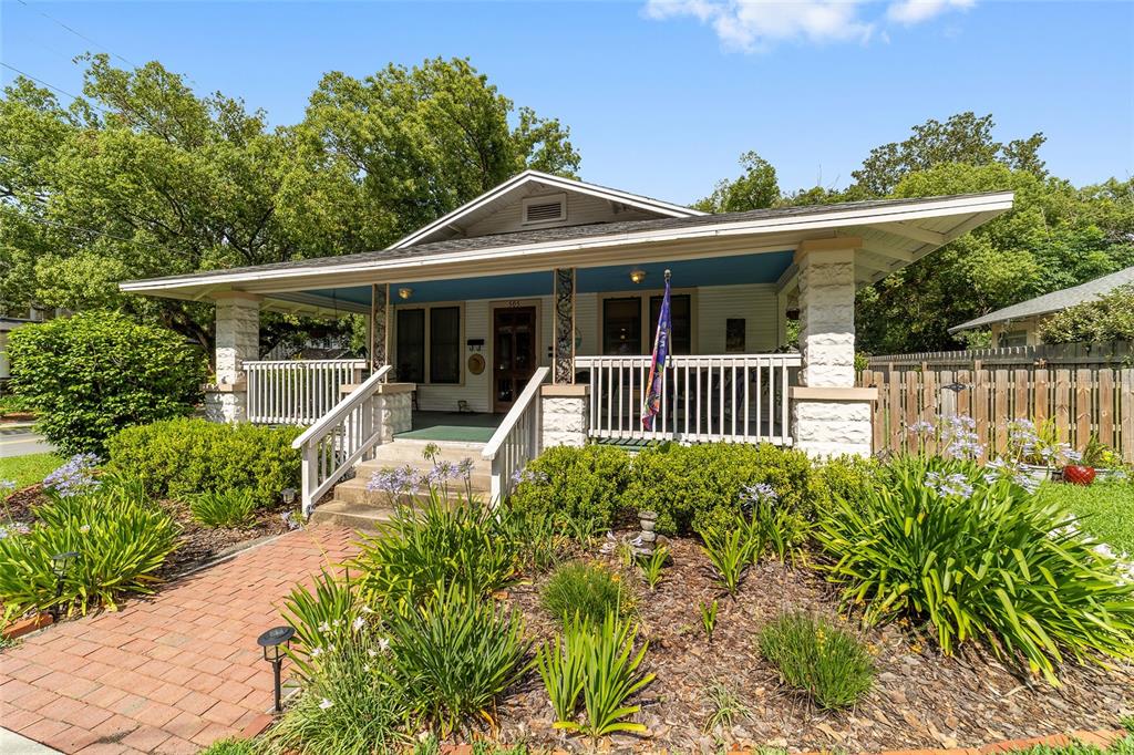 A single-story house with a wide front porch, stone pillars, and a brick walkway — 505 SE SANCHEZ AVENUE, OCALA, FL