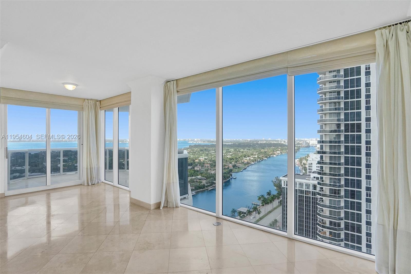 An aerial view shows a waterfront neighborhood with luxury yachts docked along a canal — 4775 Collins Ave # 3007, Miami Beach FL 33140, MIAMI BEACH, FL