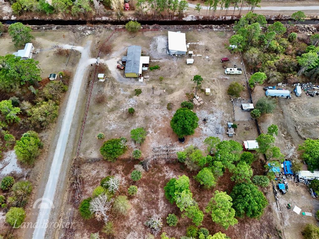 An aerial view shows a rural property with a house, outbuildings, and scattered trees — 220 N PALOMINO STREET, CLEWISTON, FL