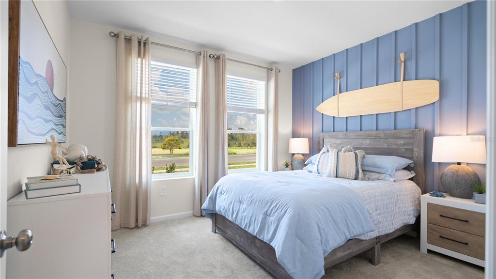 A bedroom features a blue board-and-batten accent wall with a surfboard mounted above the bed — 633 RUTH AVENUE, HAINES CITY, FL