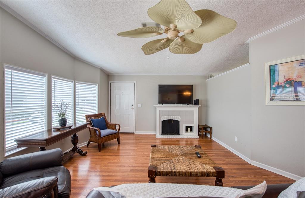 A living room features a fireplace, a ceiling fan, and hardwood floors — 480 TROUT LANE, OLDSMAR, FL