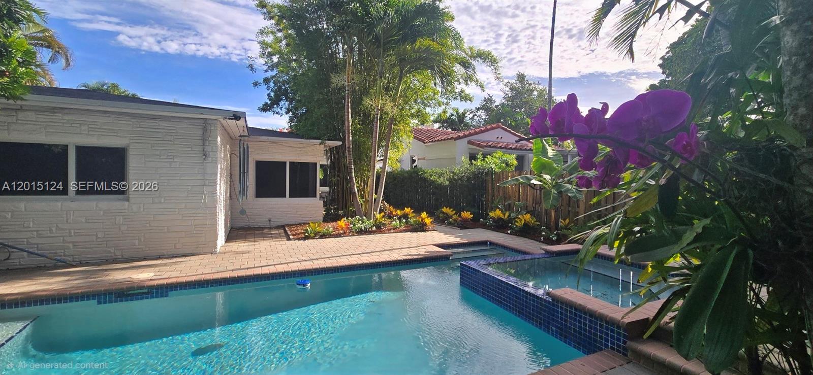 A backyard features a swimming pool, a hot tub, and a white house exterior — 634 NE 72nd Ter, Miami FL 33138, MIAMI, FL
