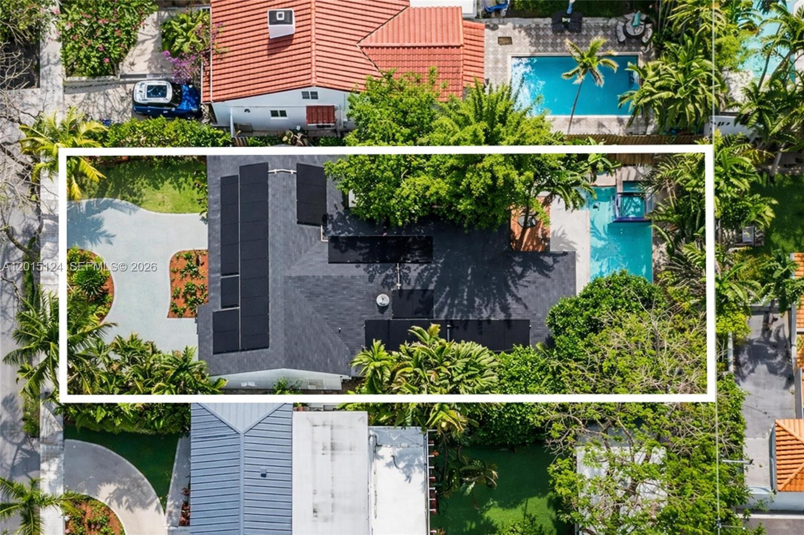 An aerial view shows a house with solar panels on its roof and a swimming pool — 634 NE 72nd Ter, Miami FL 33138, MIAMI, FL