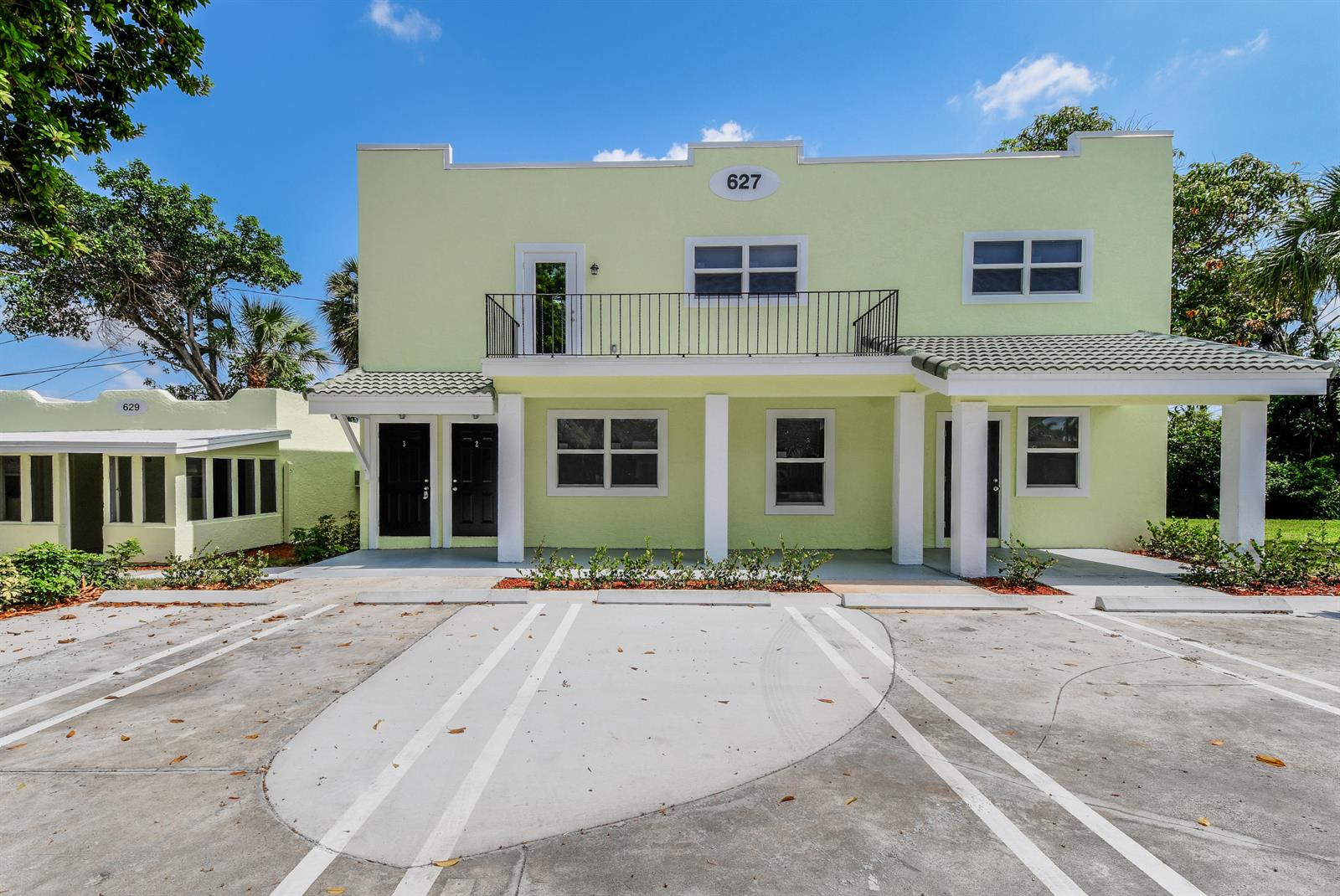 A two-story, light green building with a parking lot in front and a balcony — 627 Bunker Road, West Palm Beach FL 33405, WEST PALM BEACH, FL