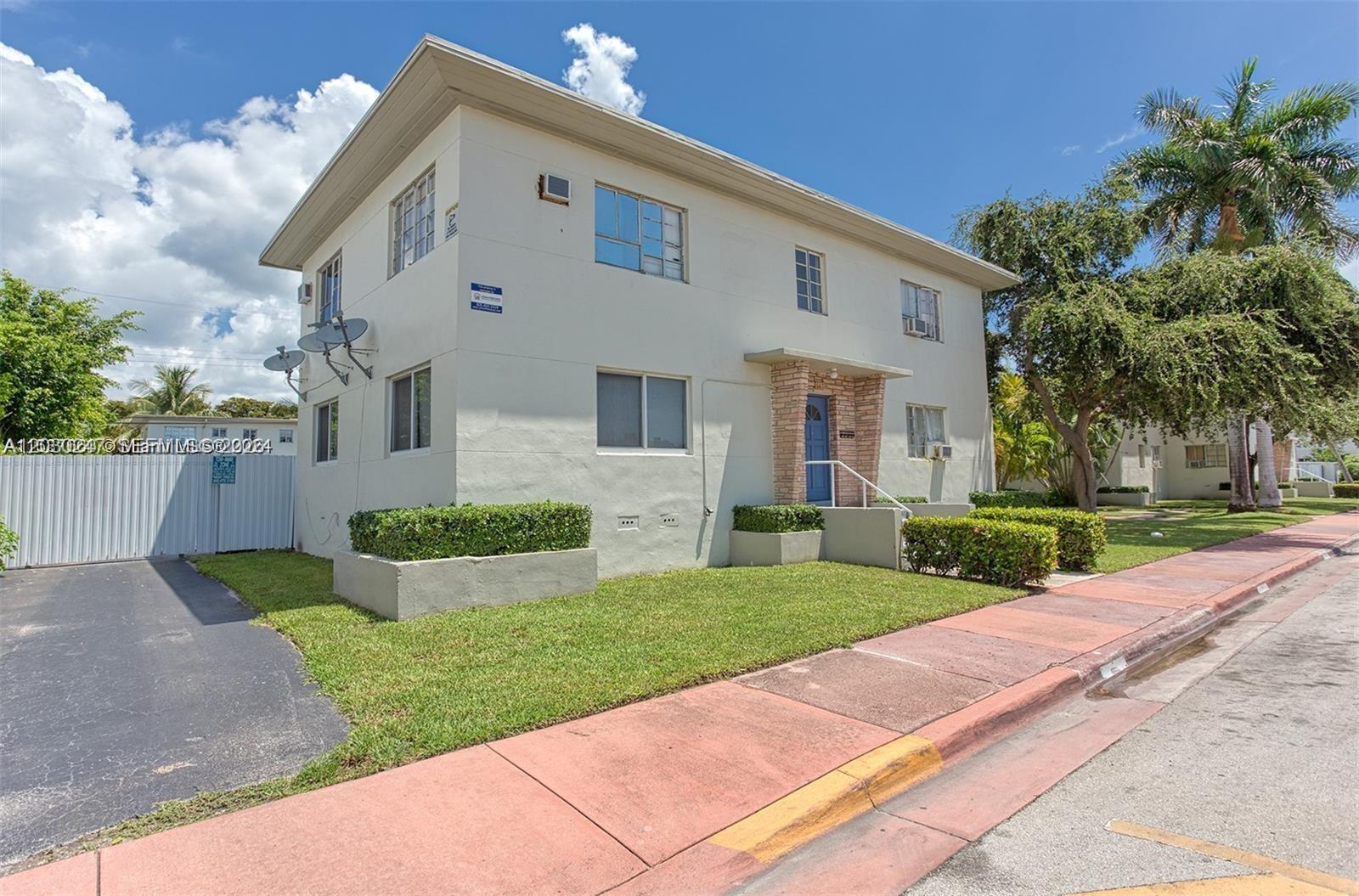 A two-story, light-colored apartment building features a blue front door and a paved sidewalk — 8320 Crespi Blvd # 11, Miami Beach FL 33141, MIAMI BEACH, FL