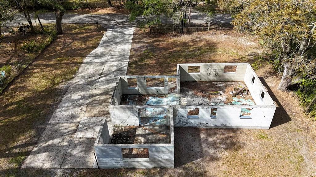 An aerial view shows the concrete block walls of a house under construction — 5515 N FALKENBURG ROAD, TAMPA, FL