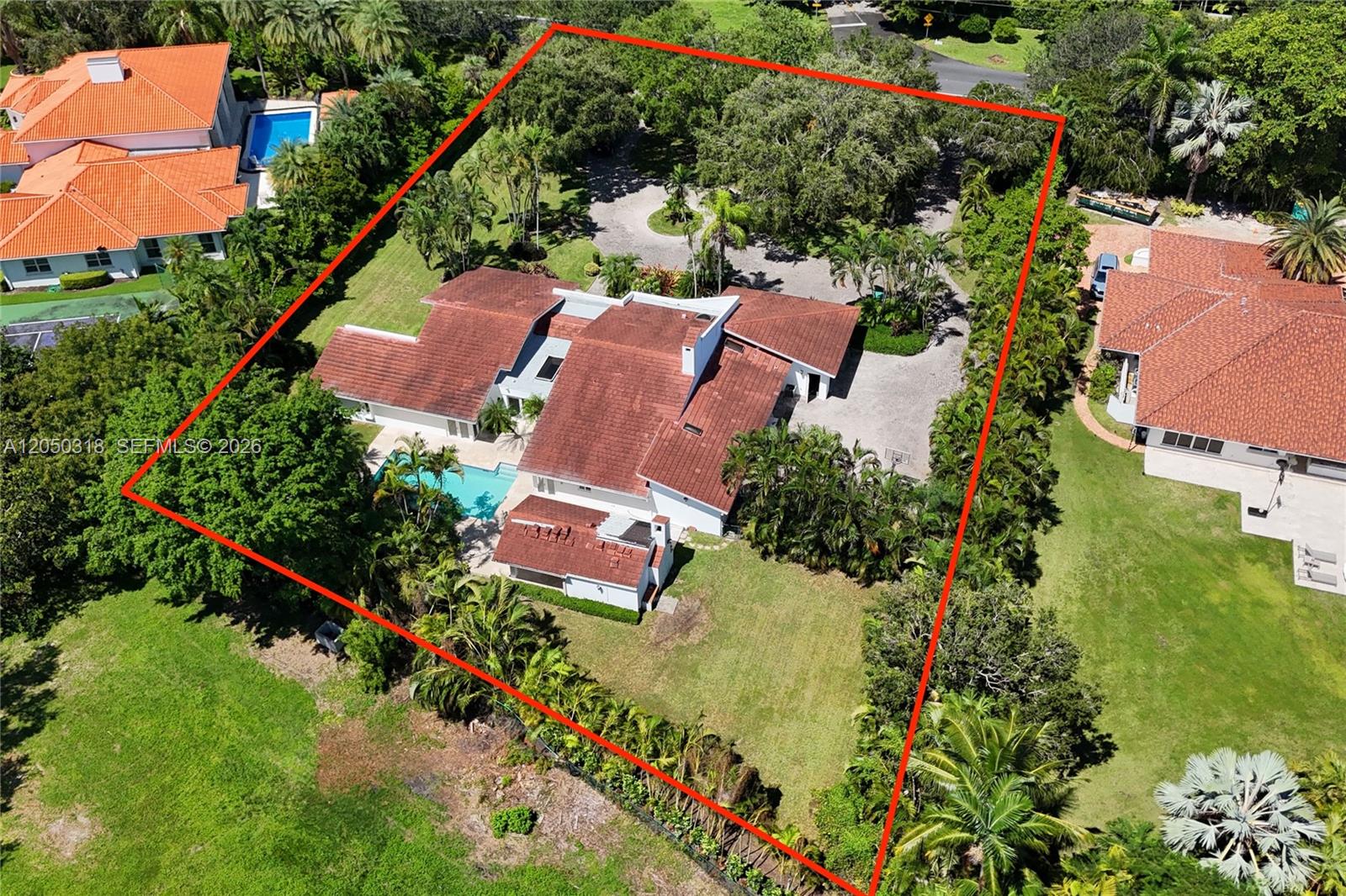 An aerial view shows a large house with a red tile roof and swimming pool — 8303 Old Cutler Rd, Coral Gables FL 33143, CORAL GABLES, FL