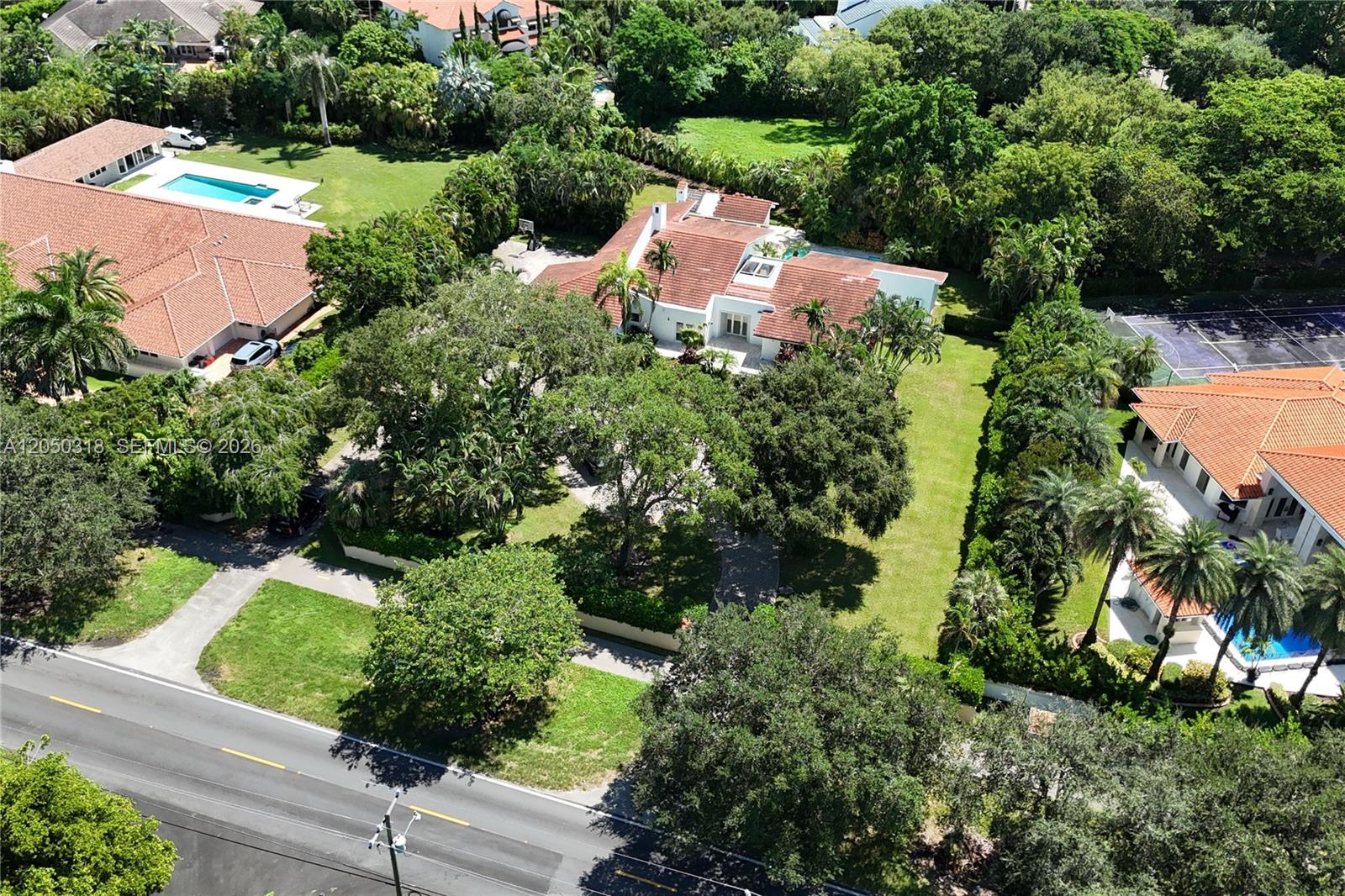 An aerial view shows a large house with a red tile roof and surrounding grounds — 8303 Old Cutler Rd, Coral Gables FL 33143, CORAL GABLES, FL
