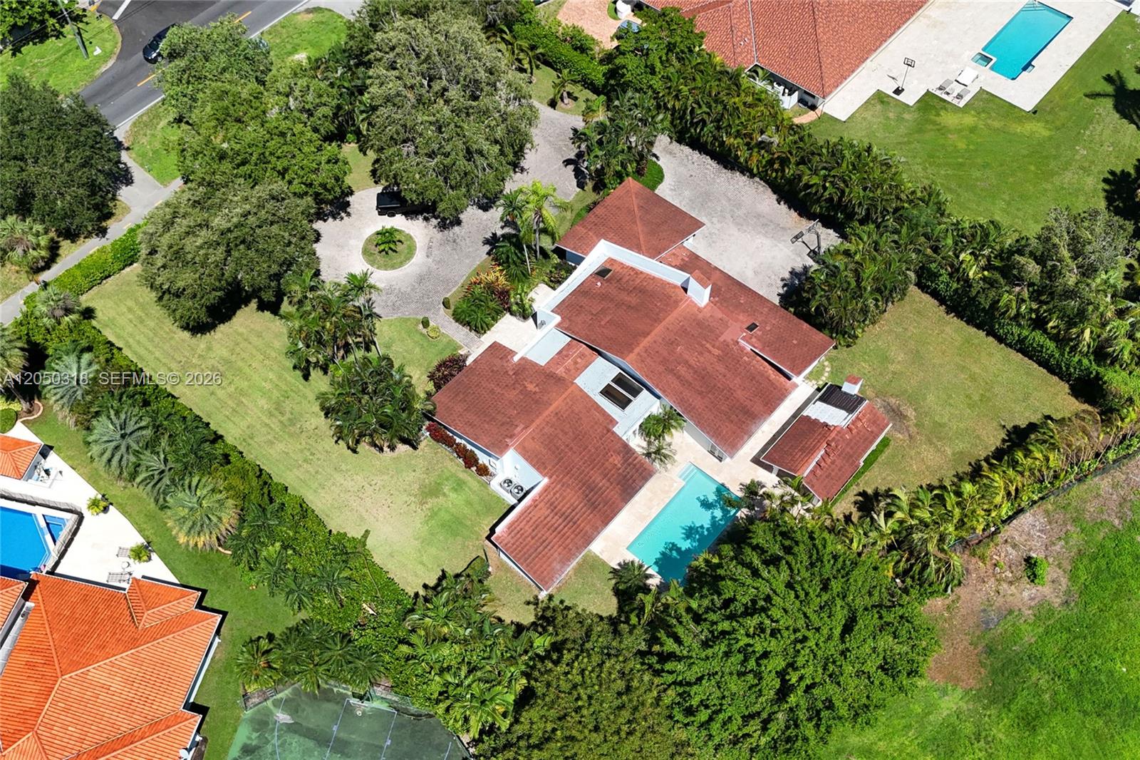 An aerial view shows a house with a red tile roof, pool, and circular driveway — 8303 Old Cutler Rd, Coral Gables FL 33143, CORAL GABLES, FL