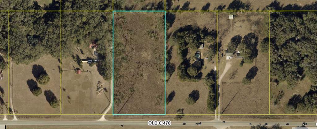 An aerial view shows a rectangular vacant lot outlined in blue along a paved road — XXX E C 470, SUMTERVILLE, FL