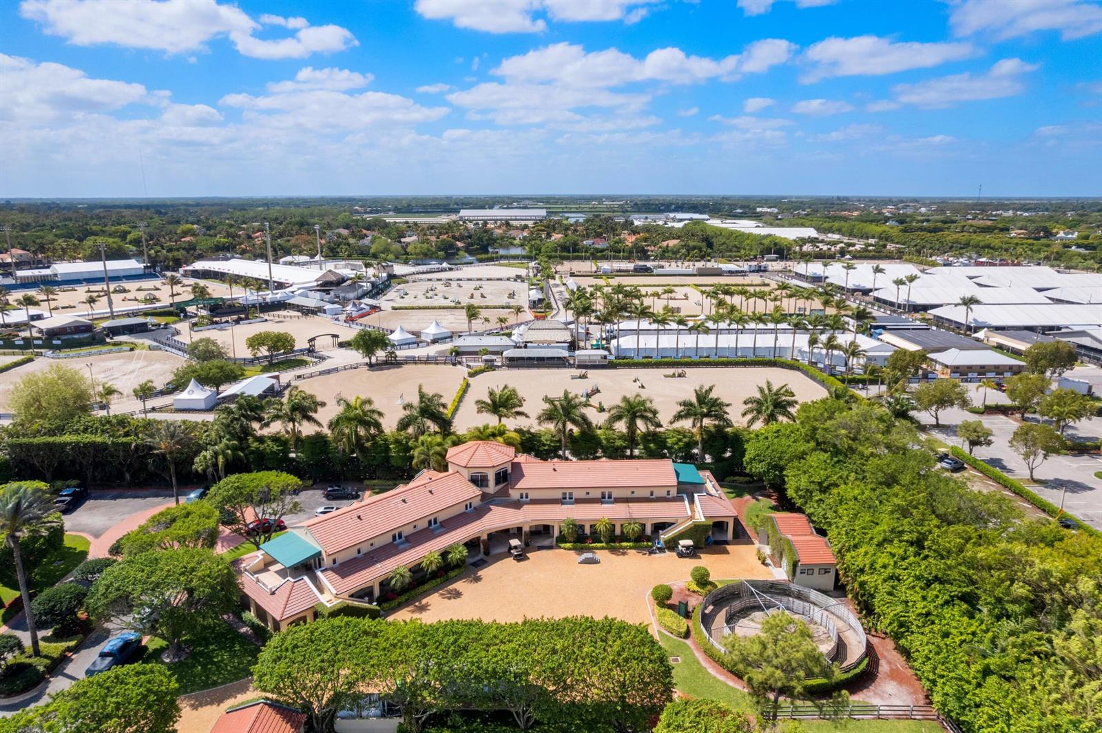 An aerial view shows a large equestrian facility with a main building and riding arenas — 3151 Hickstead Place, Wellington FL 33414, WELLINGTON, FL