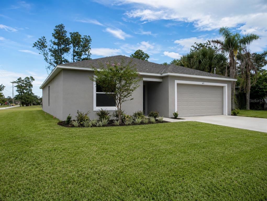 A single-story gray house with a two-car garage and a front lawn — 1691 2ND AVENUE, DELAND, FL