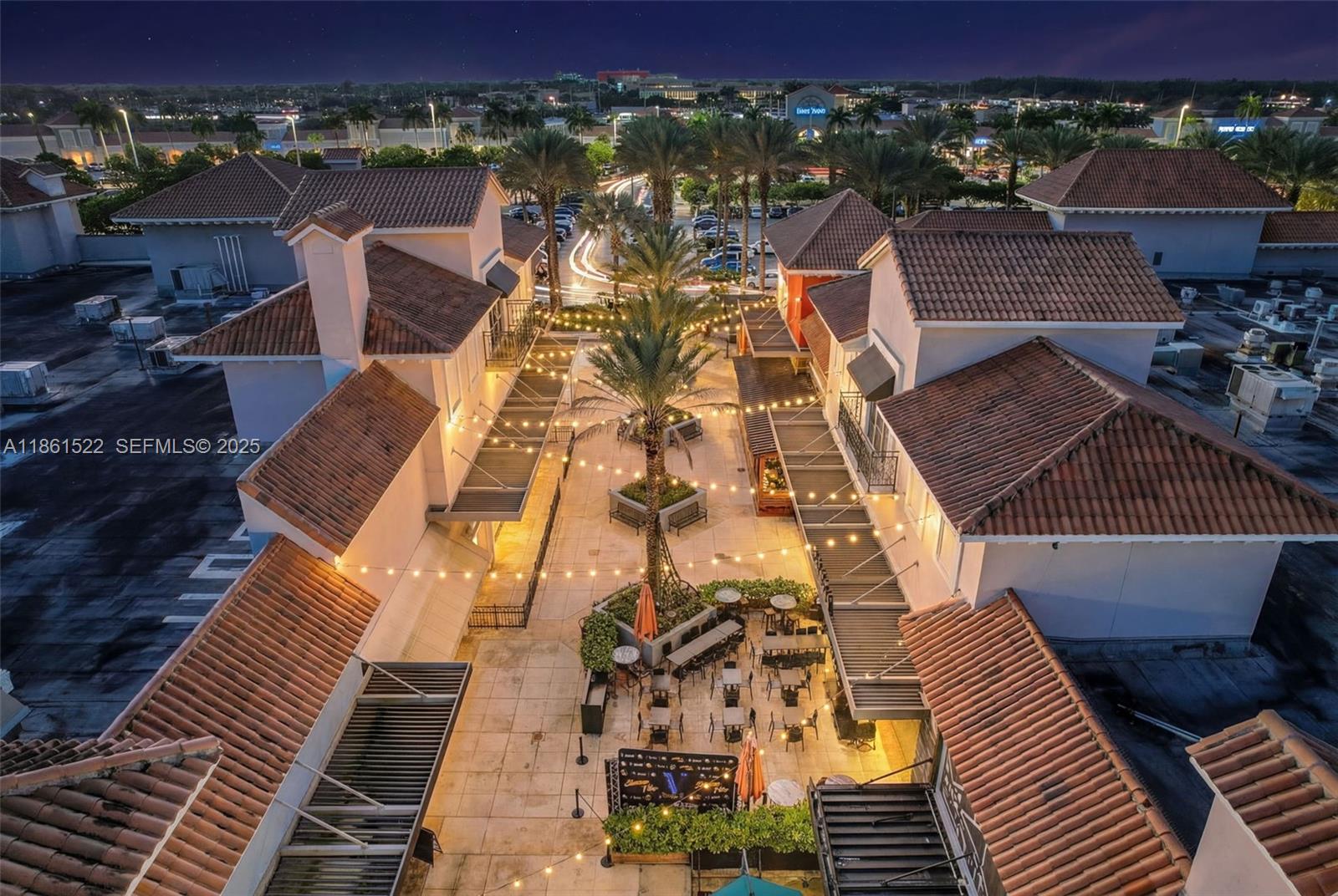 An aerial view shows an outdoor courtyard with string lights, palm trees, and patio seating — Kendall Dr, Kendall FL 33183, KENDALL, FL