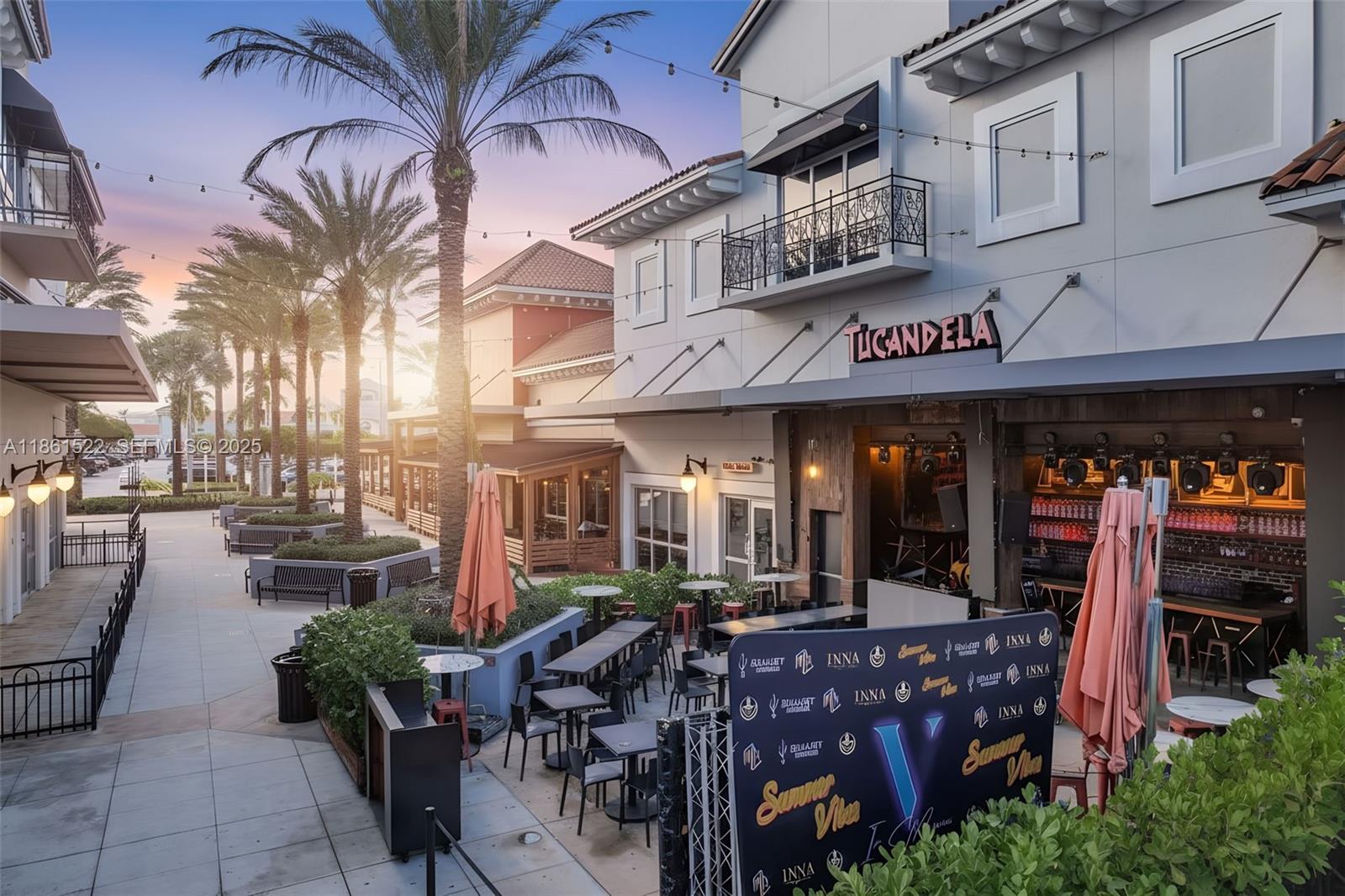 An outdoor patio area with tables and chairs sits in front of a commercial building — Kendall Dr, Kendall FL 33183, KENDALL, FL