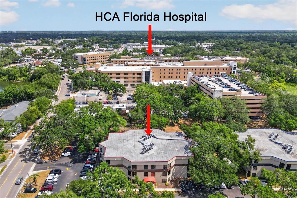 An aerial view shows a multi-story commercial building in the foreground near a large hospital — 500 VONDERBURG DRIVE UNIT 314, BRANDON, FL