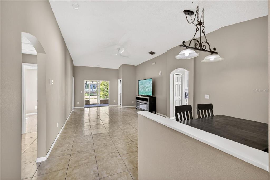 A living area with tile floors, a ceiling fan, and an adjacent dining space — 12015 CEDARFIELD DRIVE, RIVERVIEW, FL