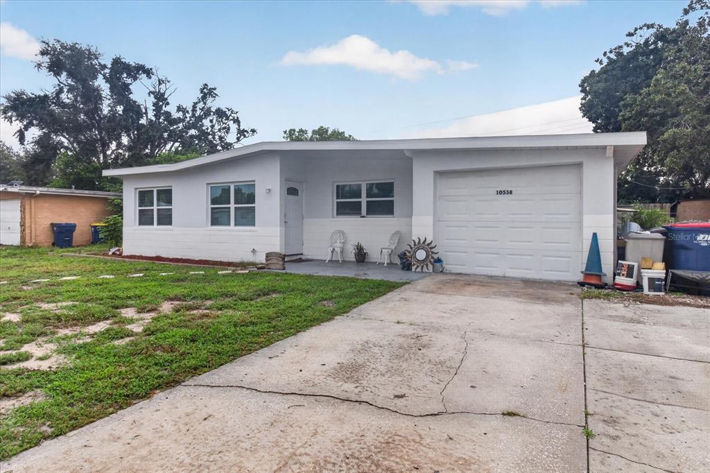 A single-story house with a white exterior, a garage, and a concrete driveway — 10538 AGATE COURT, PORT RICHEY, FL