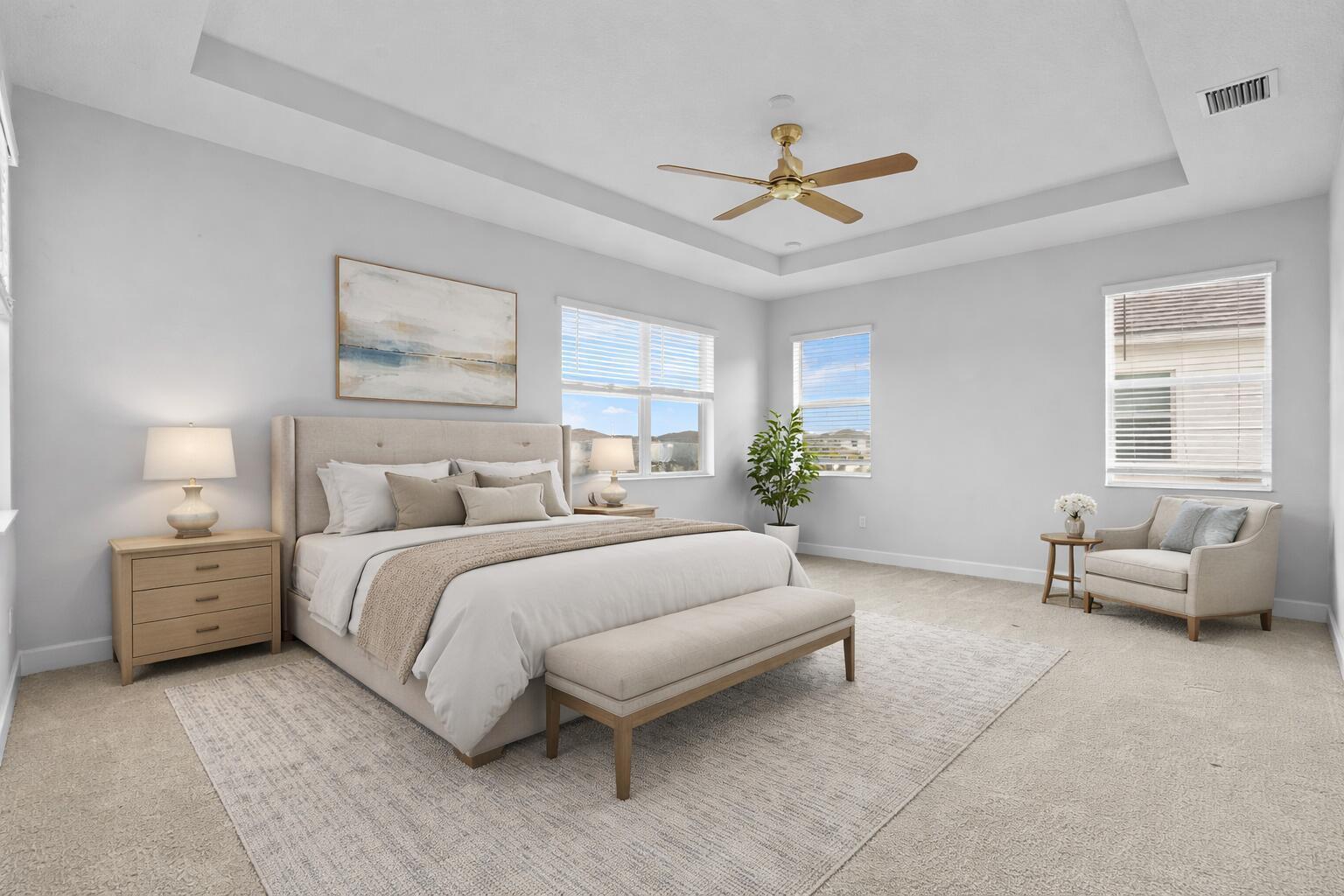 A bedroom features a tray ceiling, a bed with a bench, and a sitting area — 5338 Liberty Lane, FL 33470, FL