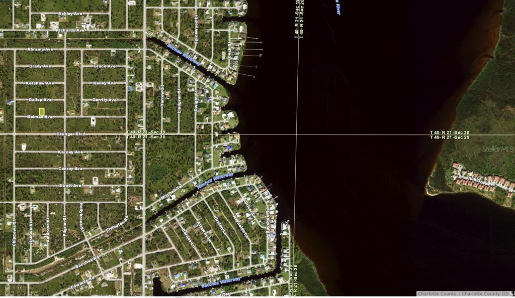 This is a satellite map view of a residential area along a waterway — 12084 BEIMAN AVENUE, PORT CHARLOTTE, FL