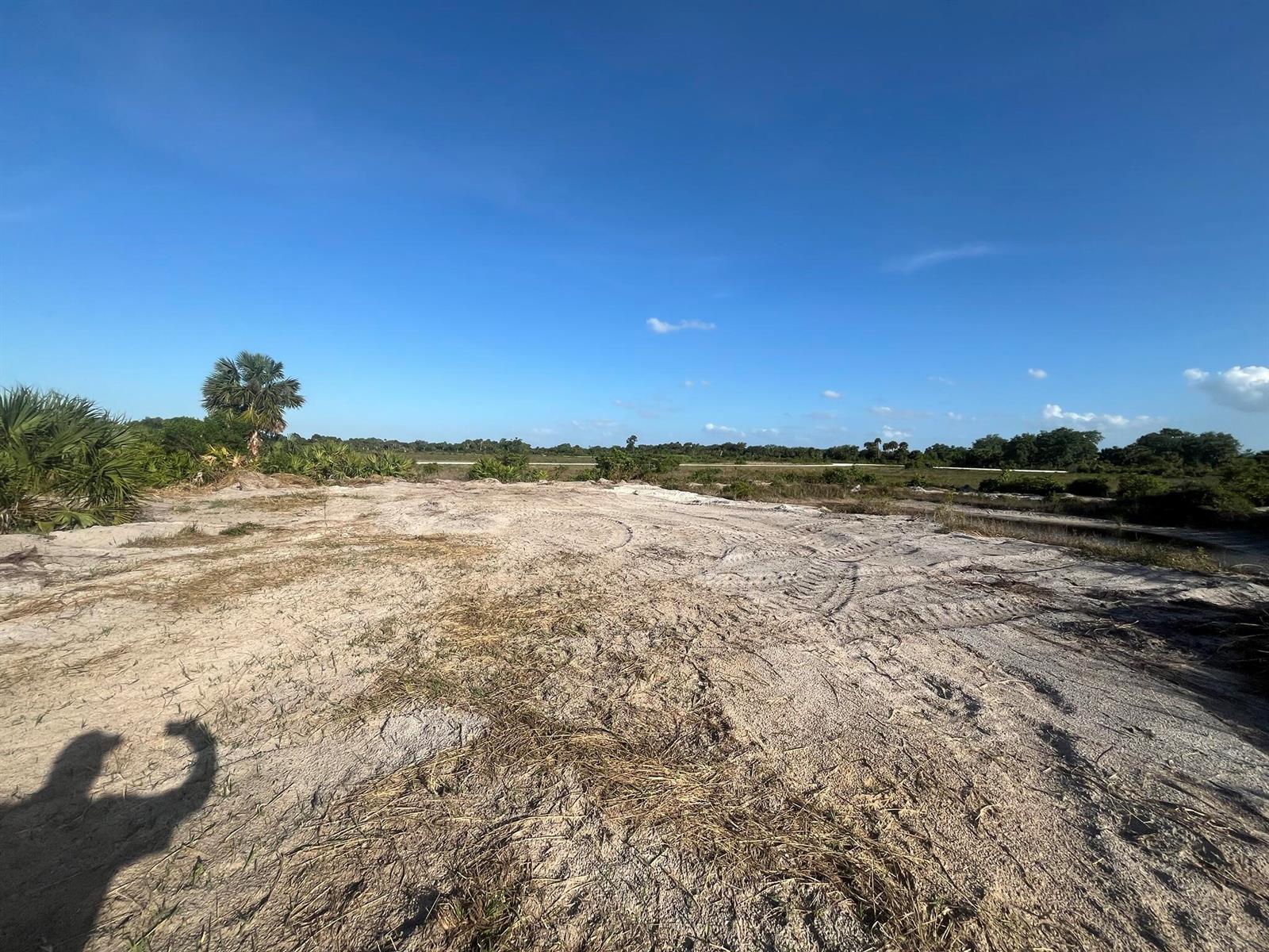 A wide, sandy, cleared lot with tire tracks under a clear blue sky — 16058 NW 290th Street, Okeechobee FL 34972, OKEECHOBEE, FL
