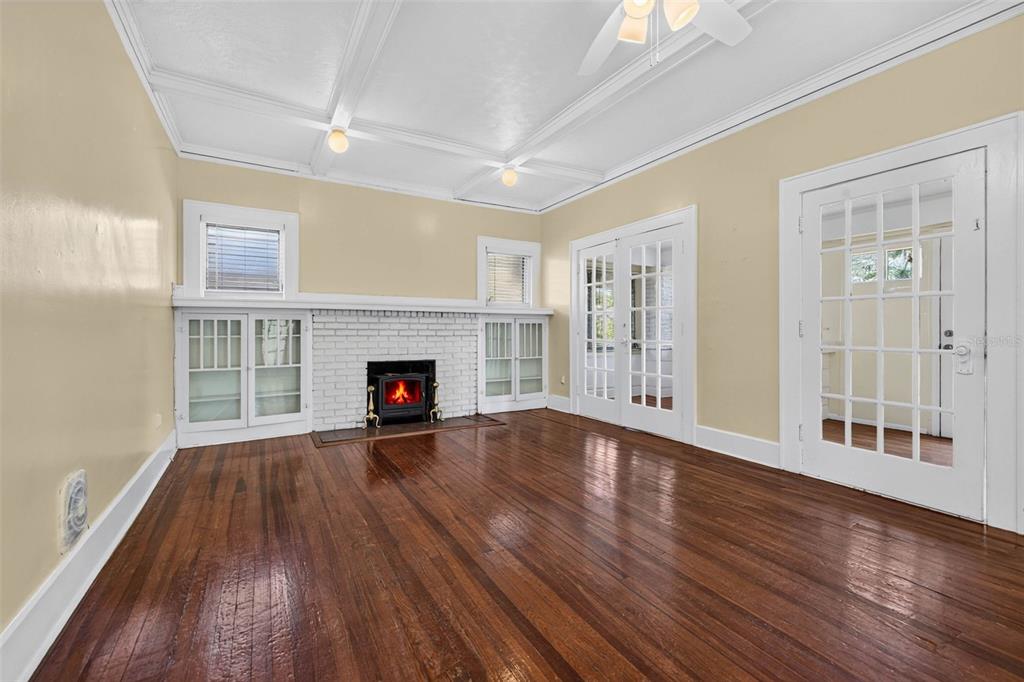 A living room features hardwood floors, a white brick fireplace, and French doors — 2800 2ND AVENUE N, ST PETERSBURG, FL