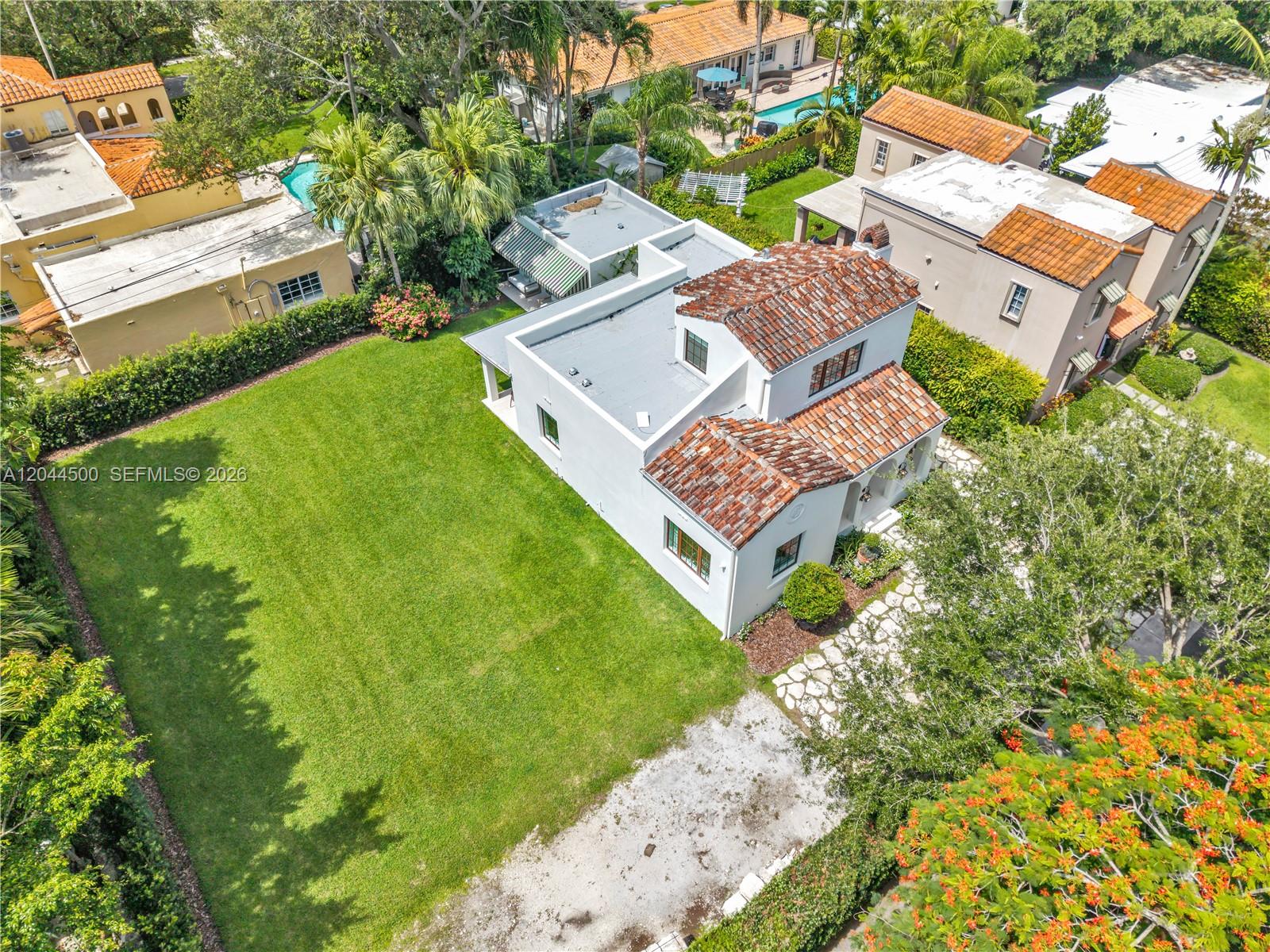 An aerial view shows a white house with a tiled roof and a large lawn — 5730 SW 49th St, South Miami FL 33155, SOUTH MIAMI, FL