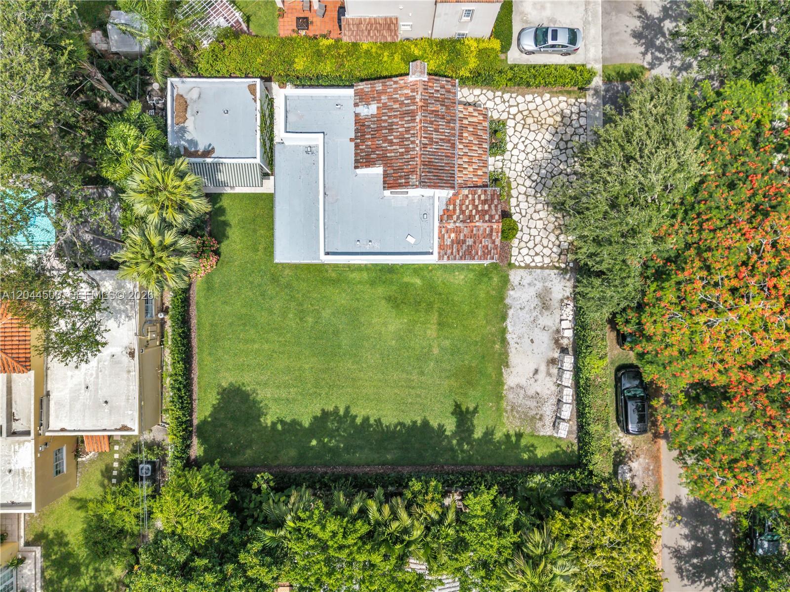 An aerial view shows a house with a tiled roof, a large lawn, and landscaping — 5730 SW 49th St, South Miami FL 33155, SOUTH MIAMI, FL