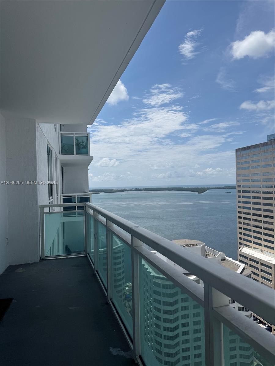 A high-rise balcony overlooks a large body of water and nearby city buildings — 950 Brickell Bay Dr # 2907, Miami FL 33131, MIAMI, FL