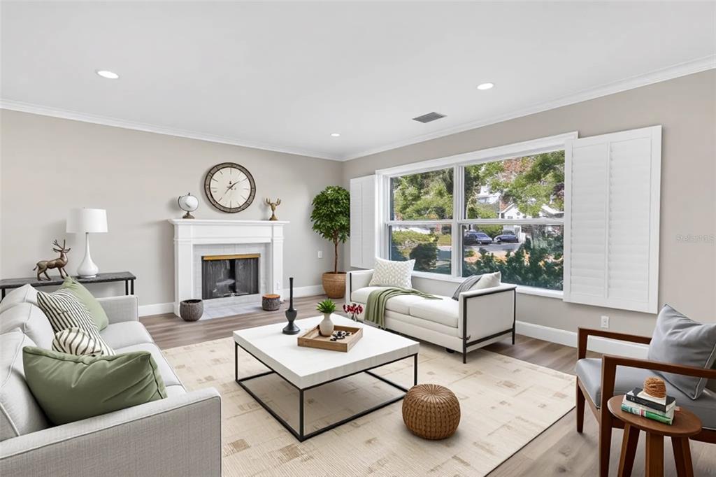 A living room features a fireplace, a white coffee table, and a large window — 216 S SHORE CREST DRIVE, TAMPA, FL