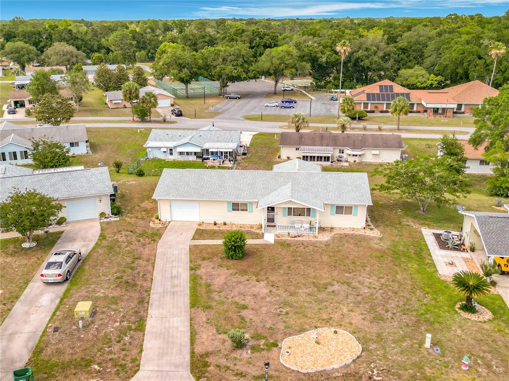 An aerial view shows a single-story house with a light-colored exterior and a gray roof — 8121 SW 107TH PLACE, OCALA, FL