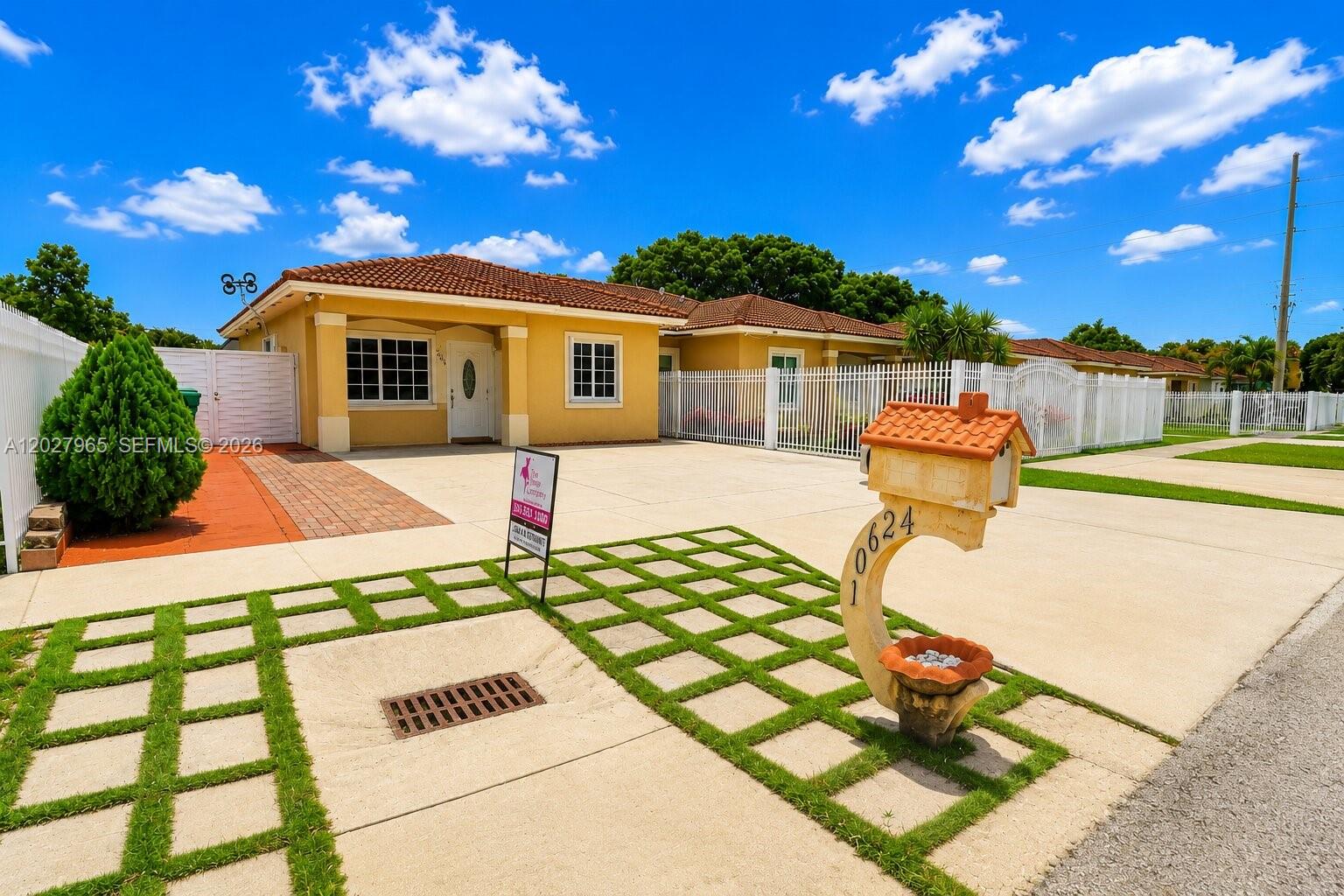 A yellow single-story house with a tile roof and a decorative mailbox in the foreground — 10624 SW 181st St, Miami FL 33157, MIAMI, FL