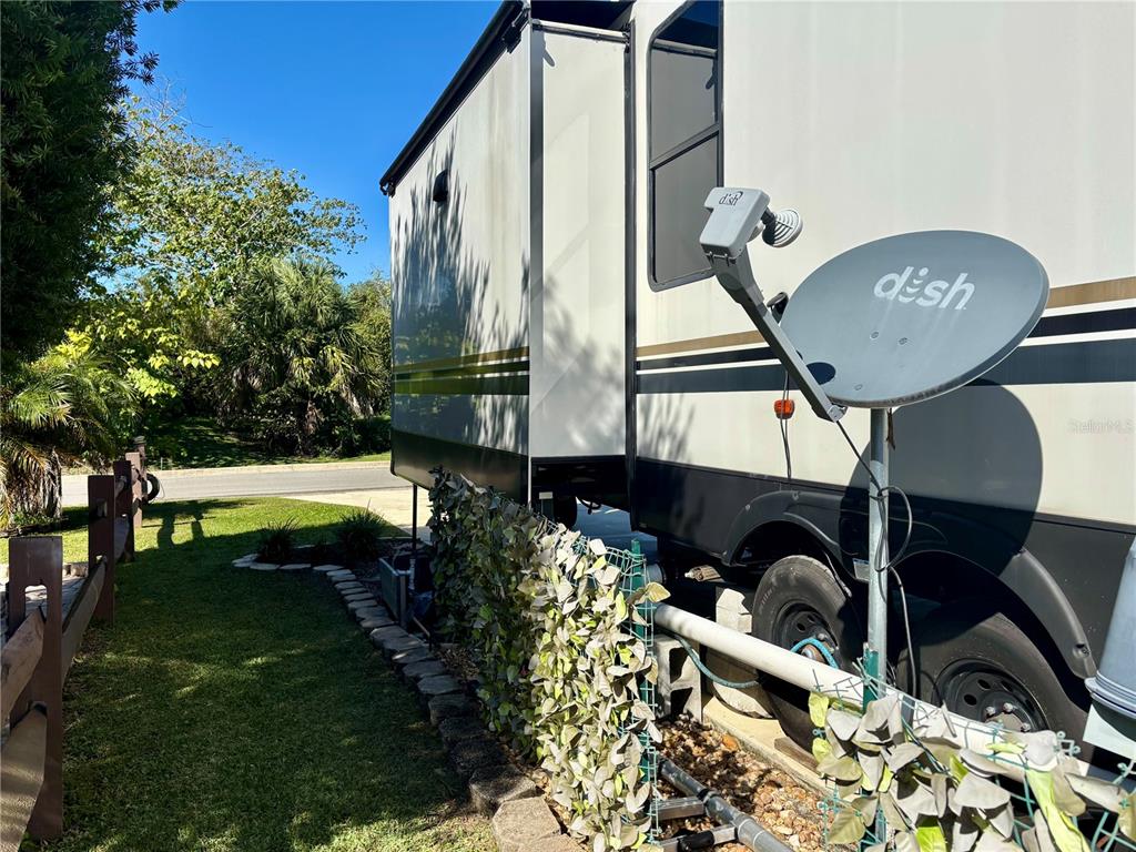 A Dish satellite dish is mounted on the exterior of a parked recreational vehicle — 3259 NE 102ND AVENUE ROAD, SILVER SPRINGS, FL