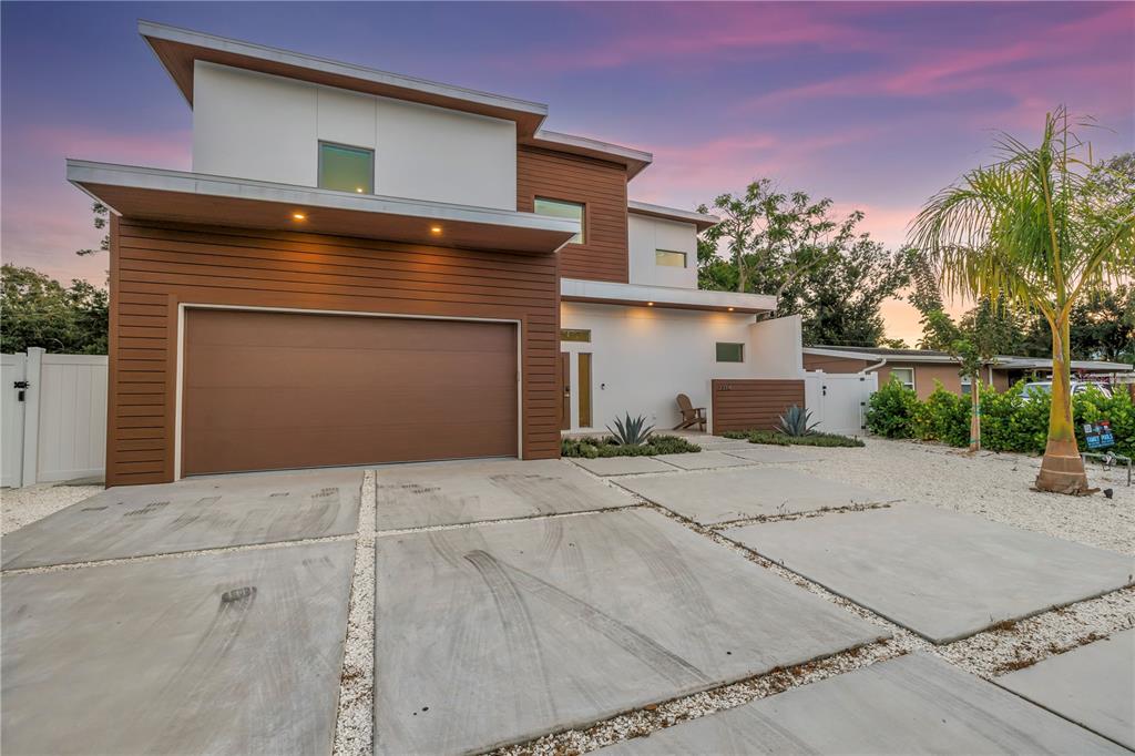 A modern two-story house with a brown garage, white walls, and a concrete paver driveway — 2314 FLOYD STREET, SARASOTA, FL