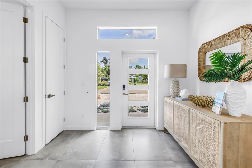 A bright entryway features a white front door with glass panels, tile flooring, and a console — 2314 FLOYD STREET, SARASOTA, FL