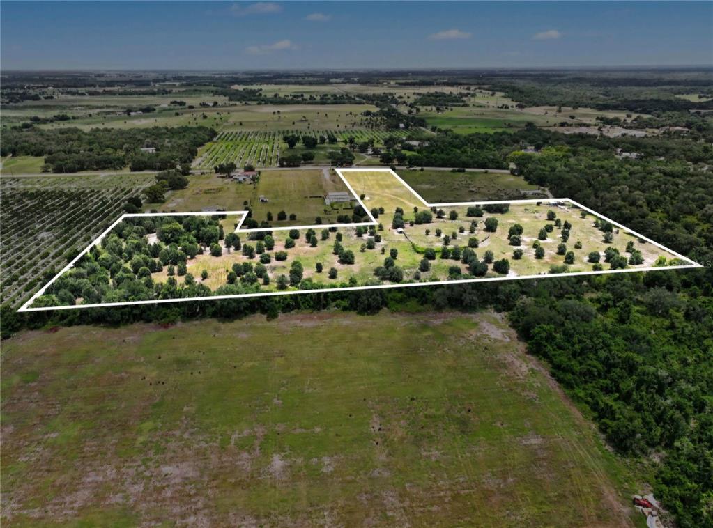 An aerial view shows a large, irregularly shaped plot of land with scattered trees — NW 70 HIGHWAY NW, ARCADIA, FL