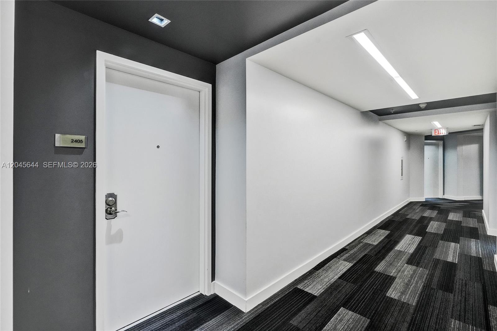 A white apartment door with a number plate sits in a modern hallway with carpet — 3301 NE 1st Ave # H2405, Miami FL 33137, MIAMI, FL