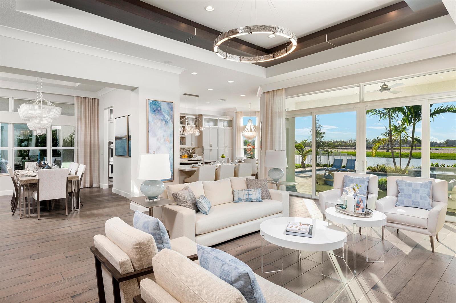 An open-concept living and dining area features wood floors, a coffered ceiling, and large windows — 11219 Sweet Sage Avenue, Boynton Beach FL 33473, BOYNTON BEACH, FL