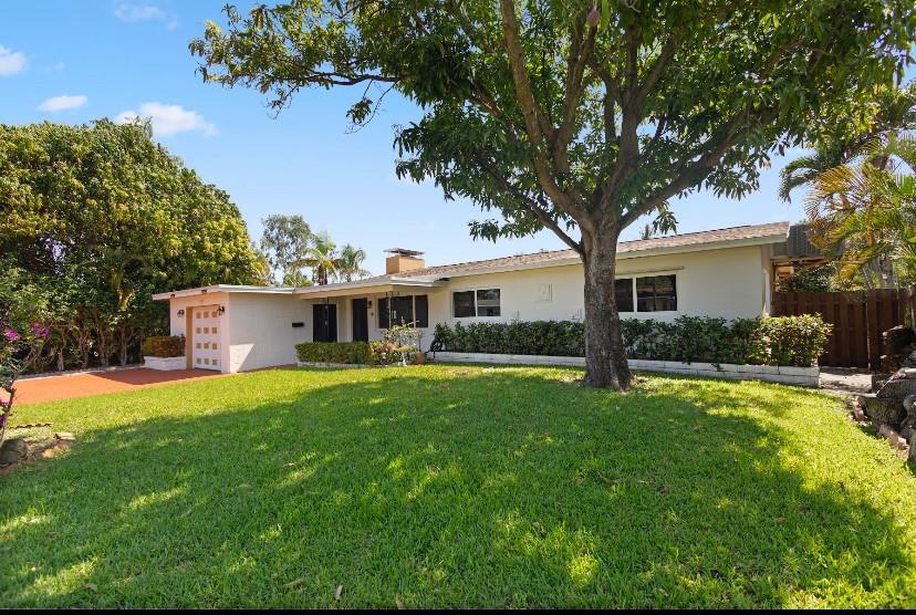 A single-story house with a white exterior, a large front lawn, and a mature tree — 570 SE 2nd Avenue, Pompano Beach FL 33060, POMPANO BEACH, FL