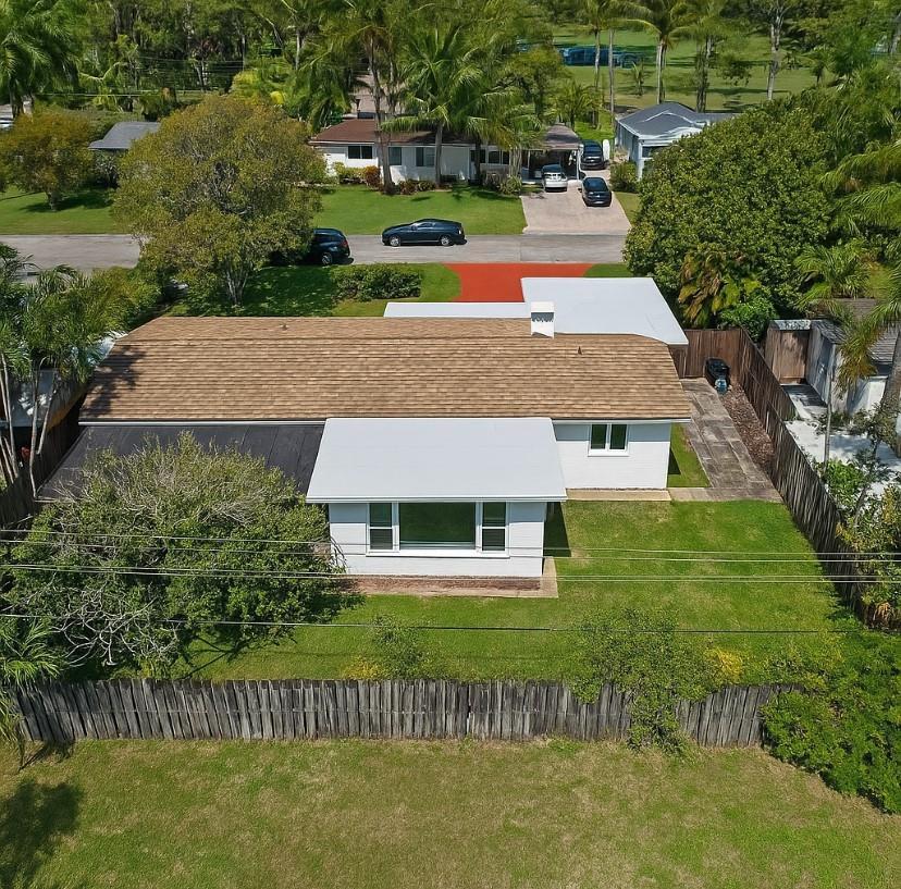 An aerial view of a single-story house with a brown shingled roof and white siding — 570 SE 2nd Avenue, Pompano Beach FL 33060, POMPANO BEACH, FL